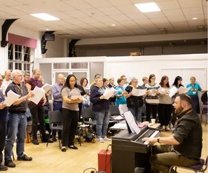 Choir circa 2019 practicing in bright hall